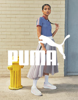 Beautiful woman with long har and Puma sneakers