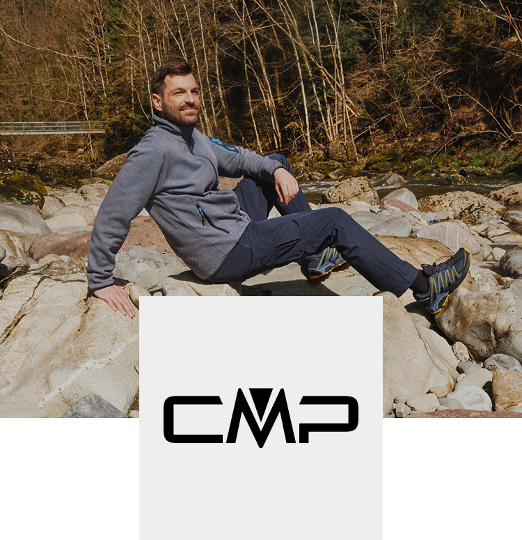 Man outdoors on a rock with CMP clothes