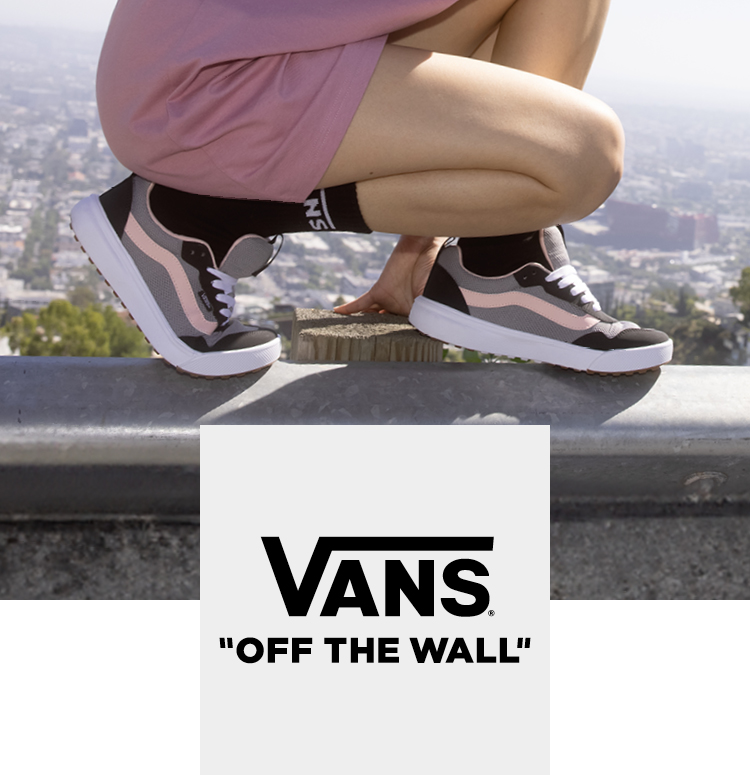 Vans sneaker on a woman in a sunny state on a wall