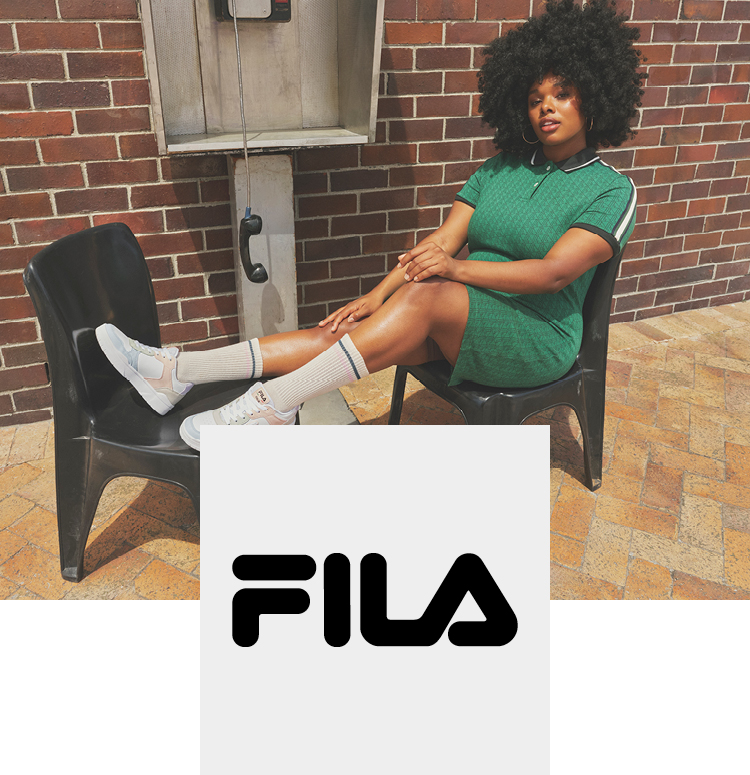 Woman at a phone booth with fila sneaker
