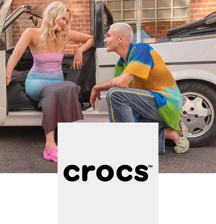 Couple in front of a car with cool Crocs shoes