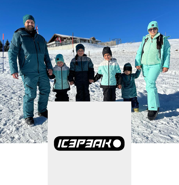 Family in the mountains with snow wearing Icepeak ski clothing