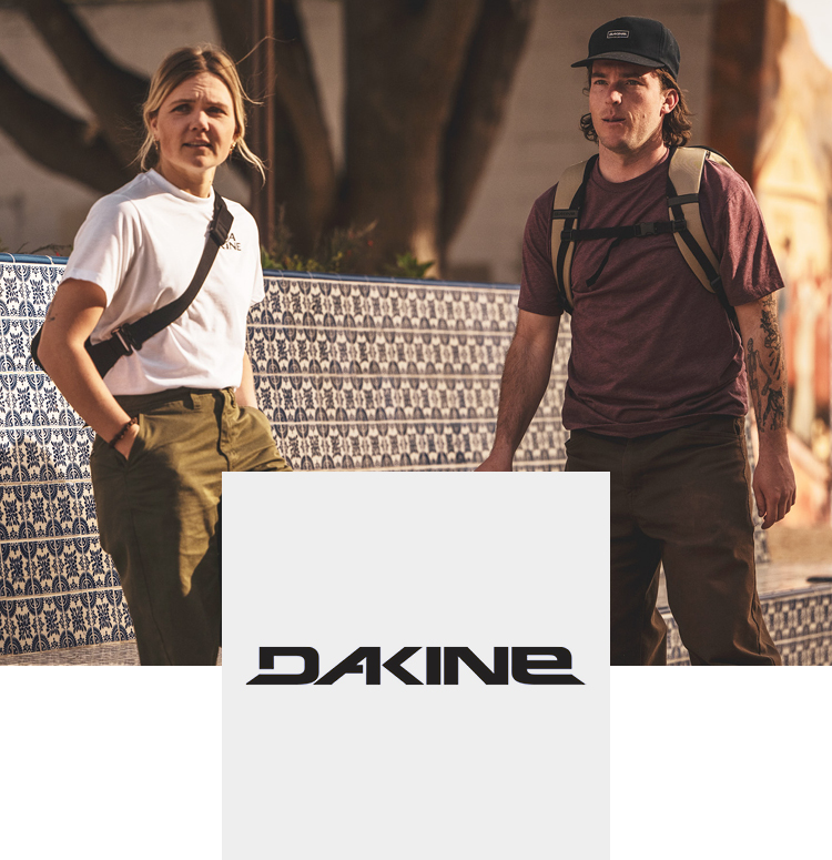 Young couple traveling with dakine bags and skateboards