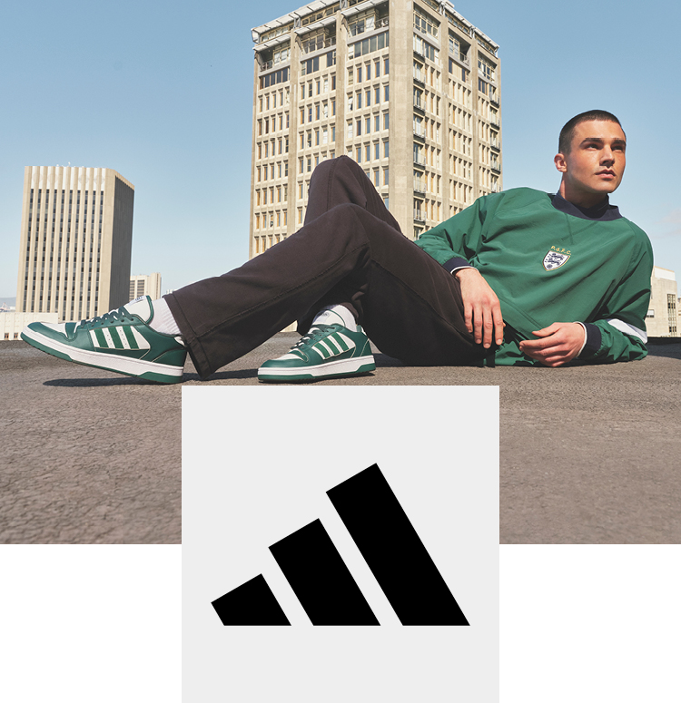 Man on a roof with adidas sneakers in retro look