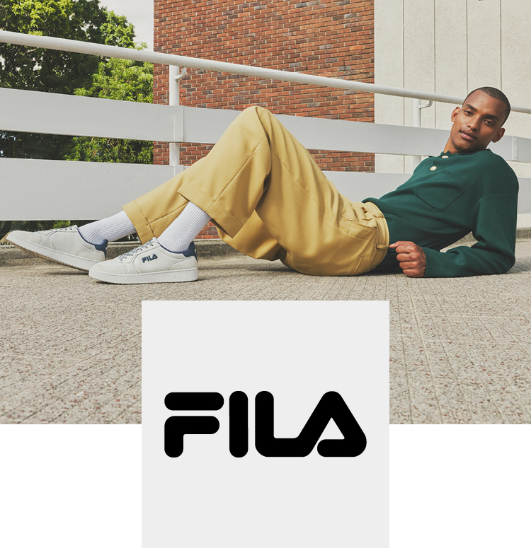 Man laying on the floor with Fila sneaker