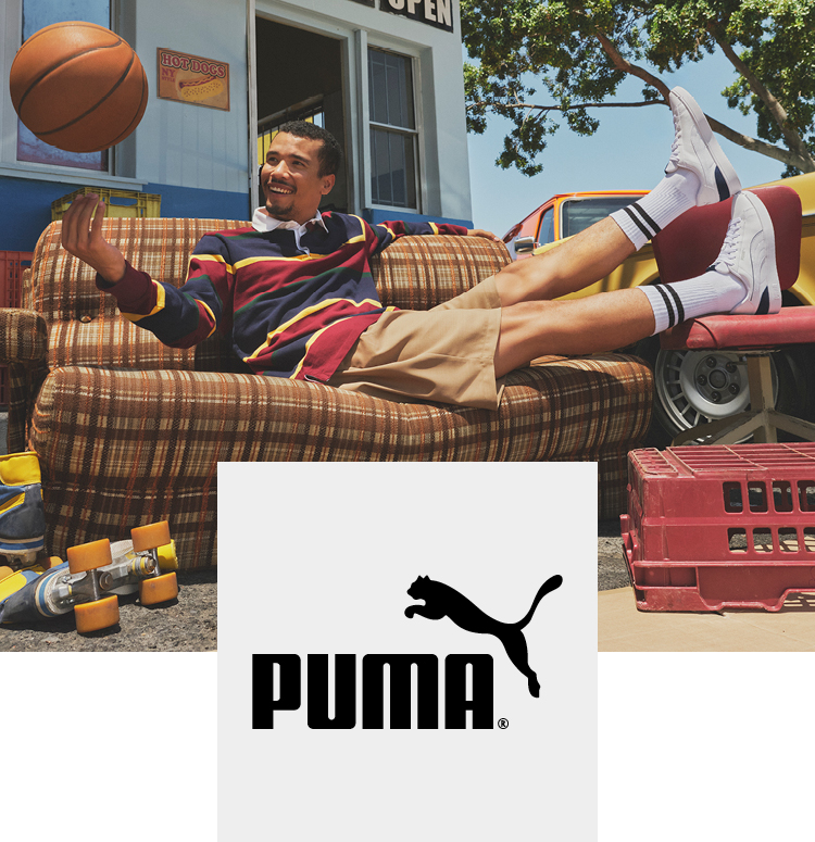 Man sitting on a couch outside balancing a basketball on his finger and wearing Puma sneaker
