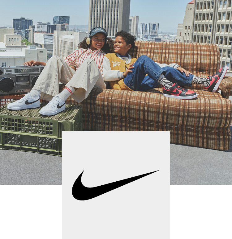 Two kids on a couch on a roof with nike sneaker