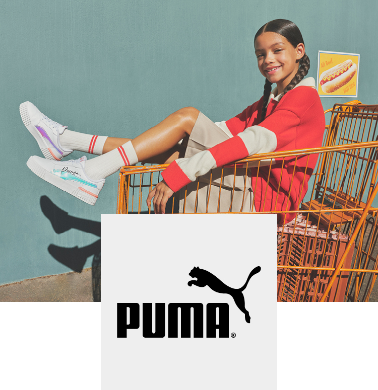 Happy girl with Puma sneakers in a shopping cart