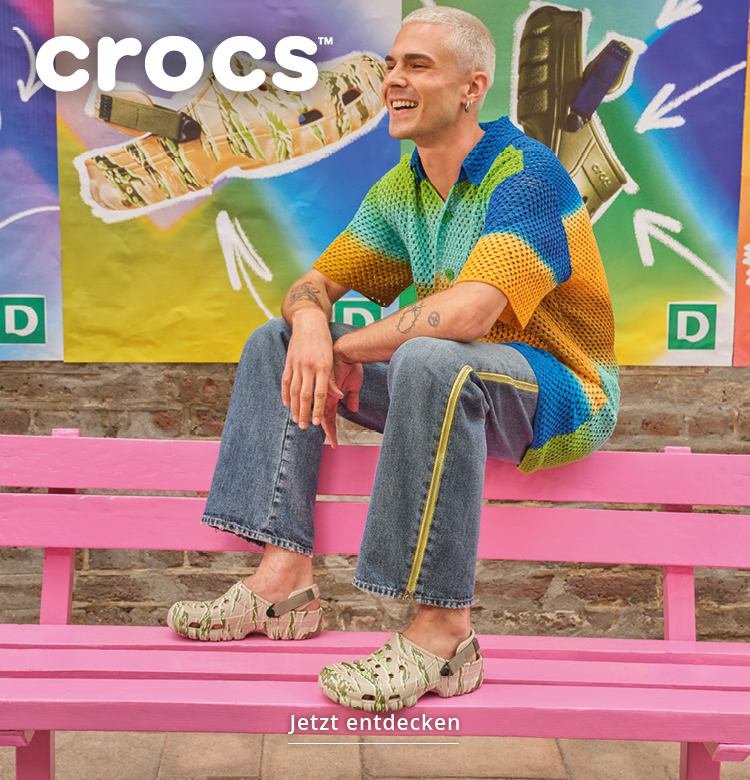 Mann auf einer Bank in neuen Crocs