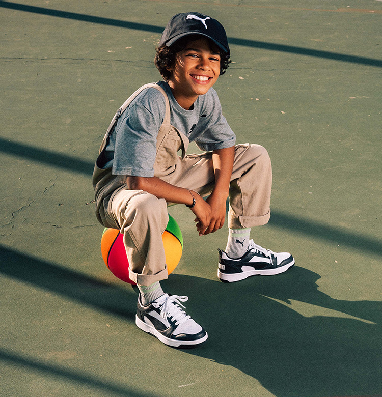 Boy on a basketball with puma sneaker