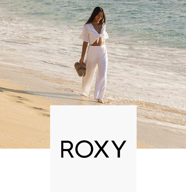 Woman at the beach with Roxy shoes