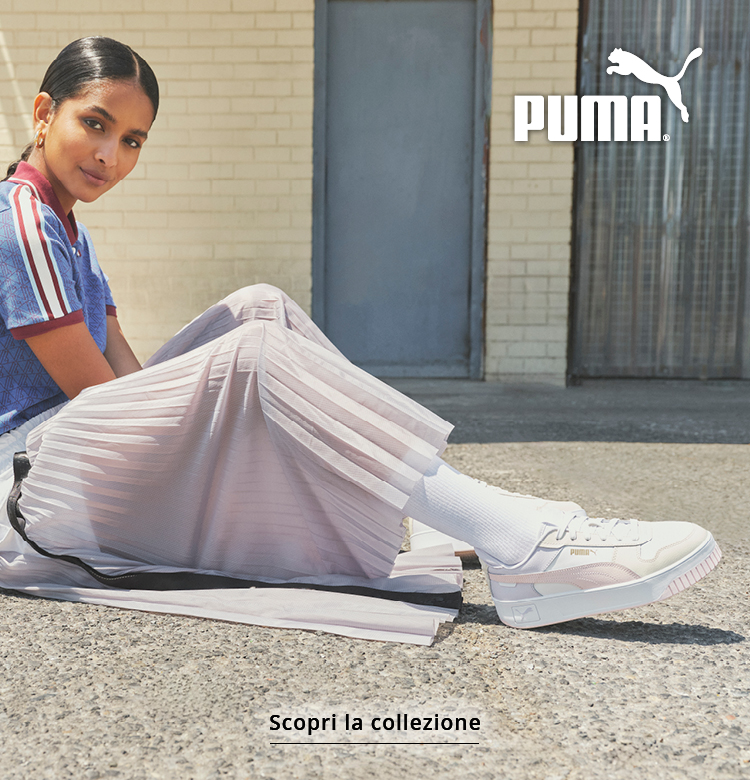 Donna con scarpe da ginnastica Puma presso un idrante