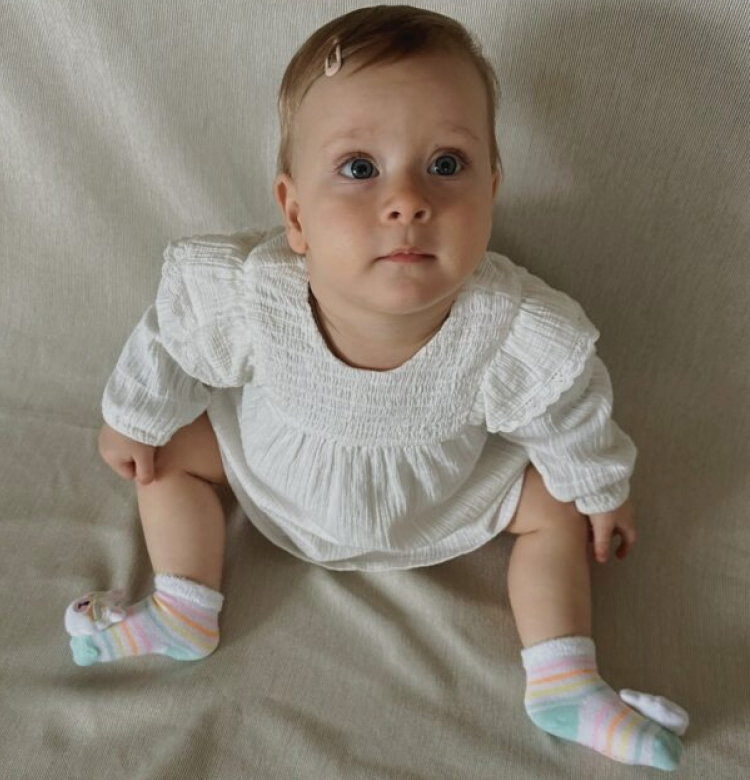 Cute baby girl with skechers rattle socks
