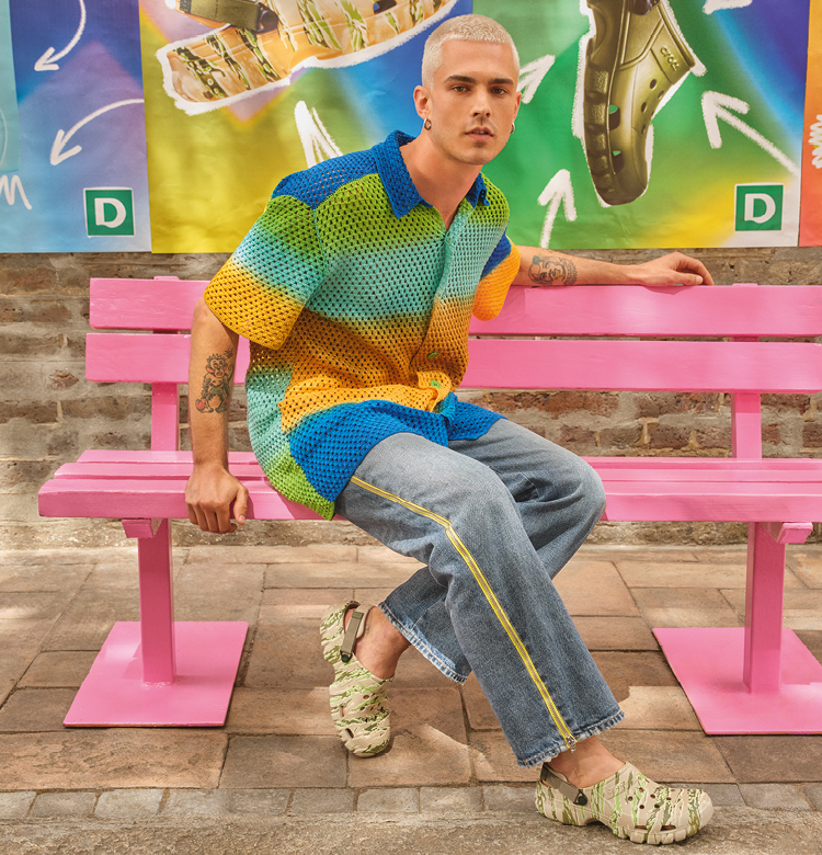 Man on a bench with new Crocs